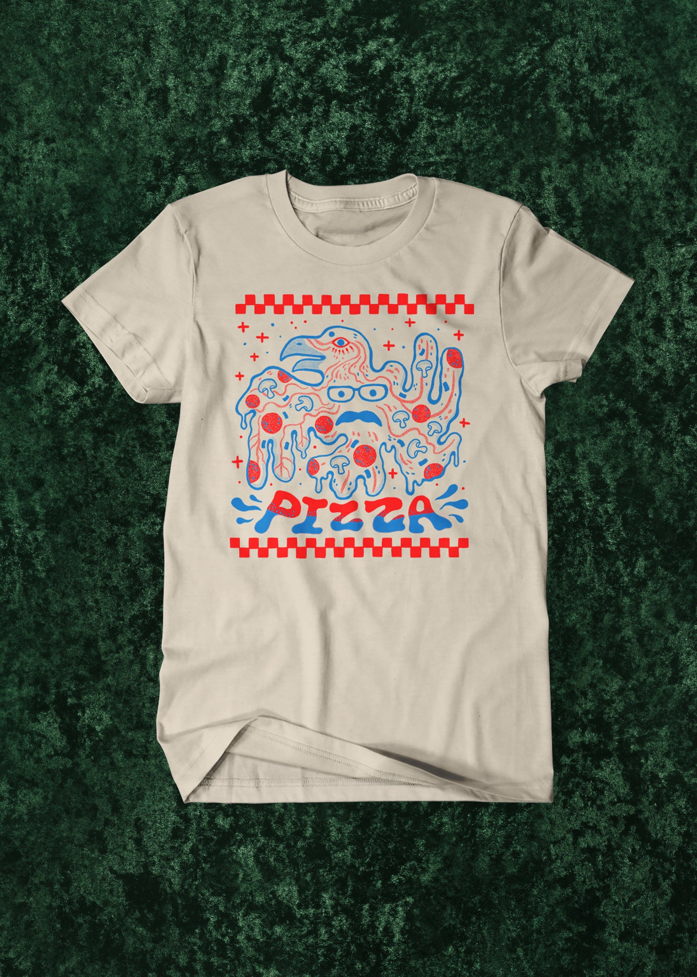 Beige t-shirt with colorful bird and pizza-themed graphic on a textured green background