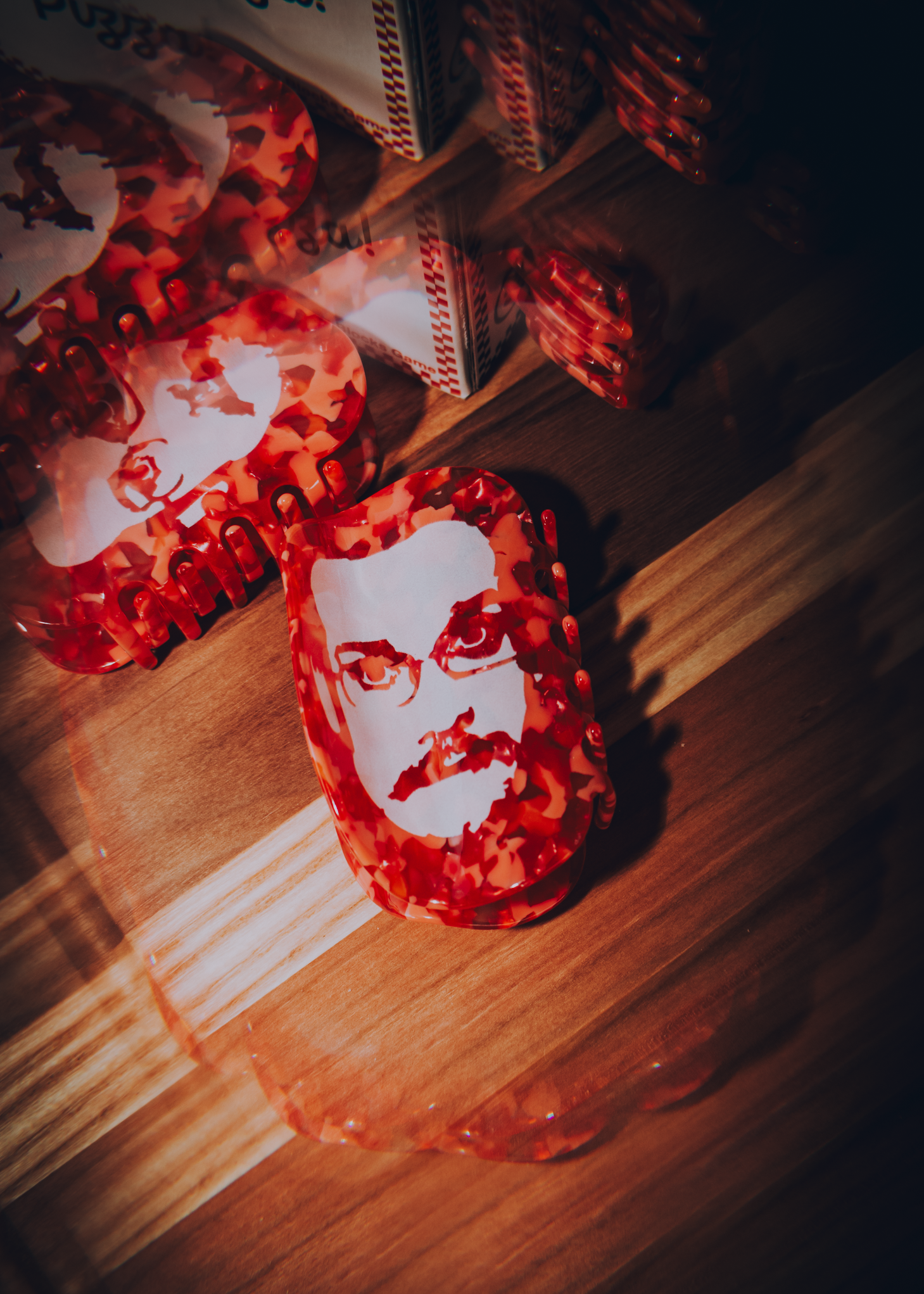 Red hair claw with a white face Pizza John face on a wooden surface